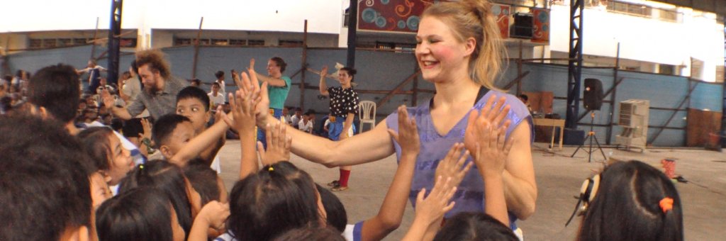 Clown gör high five med en grupp av barn